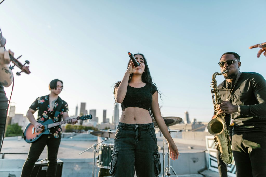 Live music band performing on a rooftop with skyline view at sunset. Energetic and vibrant atmosphere captured perfectly.